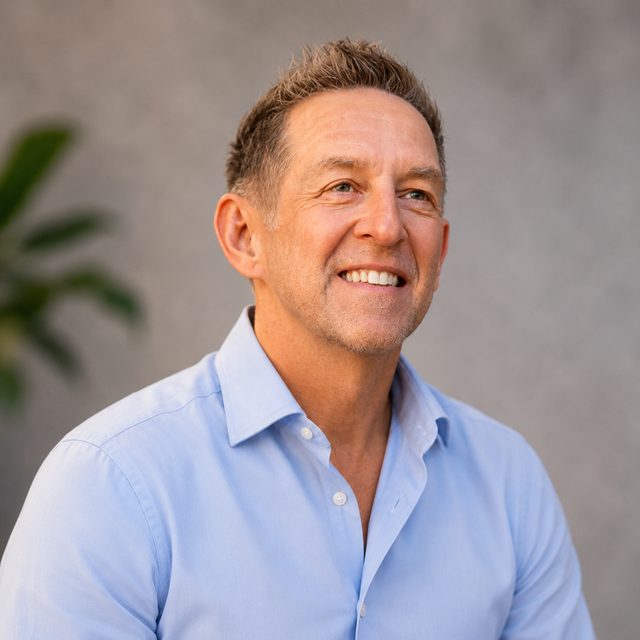 Mark Osenga, Fractional Chief Operating Officer, smiling in a light blue shirt